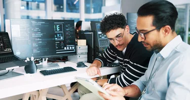 Web developer, tablet and coding in office for software, system or website update advice. Night, programmer and backend engineer with feedback for company development, teamwork or workplace project